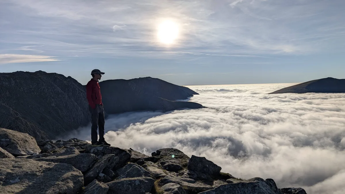 Simon standing above a mountain cloud inversion